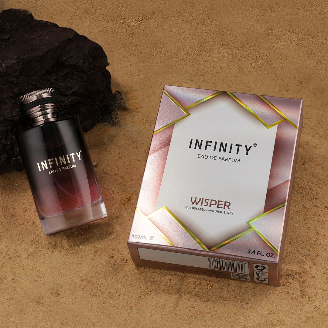 infinity-wisper-eau-de-perfume-100ml-bottle-and-packaging-on-sand-and-rock-in-the-background