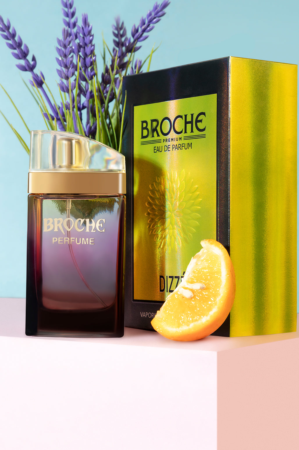 broche-dizze-eau-de-parfum-bottle-and-packaging-with-flowers-and-orange-slices