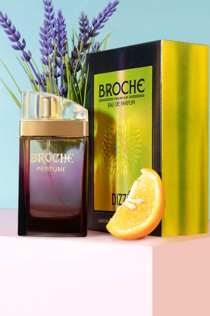 broche-dizze-eau-de-parfum-bottle-and-packaging-with-flowers-and-orange-slices